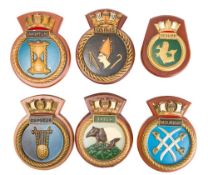 A group of nine plaster and composition Royal Navy wardroom badges: including HMS 'Astute',