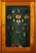 A framed display of various Naval and yacht club cap badges: including 'Royal Alfred Yacht Club',