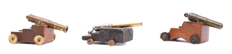 A small brass and teak model of a cannon made with material from HMS Magpie:, 9cm long,