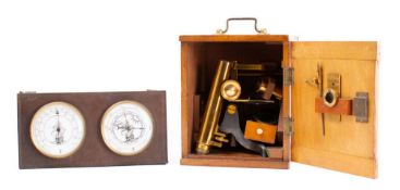 A lacquered brass student microscope: the monocular tube with coarse/fine adjust over a fixed stage