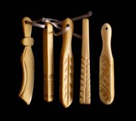 A set of five 19th century carved bone teethers: one in the form of a scimitar,