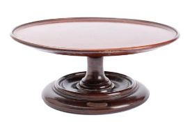 A mahogany Lazy Susan constructed from timber taken from HMS Britannia: the circular top with