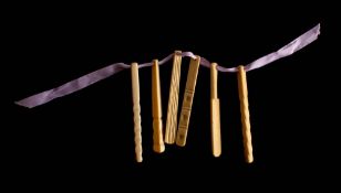 A set of six 19th century carved bone teethers: one in the form of cricket bat,