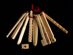 A set of nine 19th century bone teethers: in the from of tools and a cricket bat,