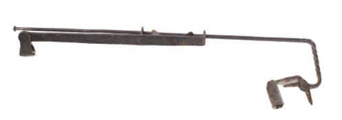 An iron adjustable candle holder: with sliding rod and hinged candle sconce, 57cm high,