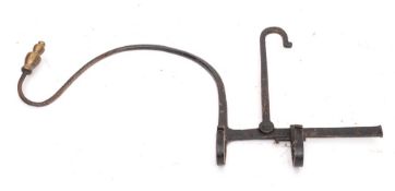 A wrought iron kettle tilt: of plough pattern with brass urn finial, 18th Century.