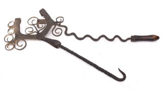 A decorative Scottish wrought iron kettle tilt: with scroll decoration and irregular handle with