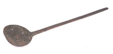 A rare medieval copper scummer: with shaped and hammered tapering handle, 44cm.