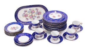 A Continental blue and gilt banded part dinner and tea service: with floral spray decoration.