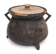 A bronze twin-handled cauldron: of traditional bag shape with angular handles,