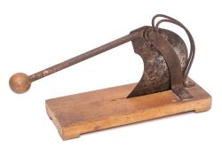 An iron baguette slicer: with ball terminal and beechwood oblong base:, 30 x 12.5cm.
