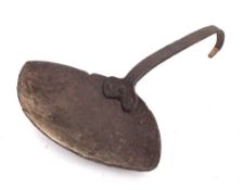 A wrought iron grisset pan: of navette shape, the handle with scroll end, 17th/18th Century.