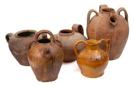 A large French terracotta olive oil jug: of oviform shape with triple handles, 39cm high,