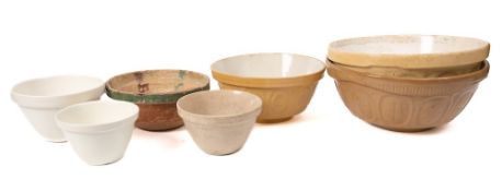 A pottery and green glazed circular colander: with single handle, 26cm diameter,
