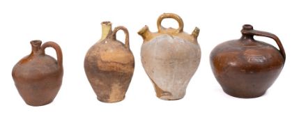 A stoneware olive oil jug: with three handles and raised decoration,