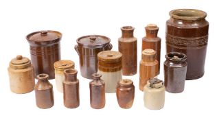 A collection of various brown glazed stoneware storage jars: and ink bottles.
