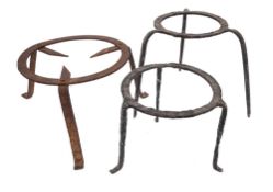 Two circular cast iron brandreths: on splayed legs,