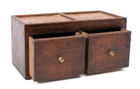 An oak two drawer spice chest: with twin burr inset panel top, 25cm wide.