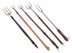 A brass three pronged toasting fork: with turned and ebonised handle,