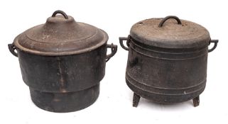 A Continental cast iron cooking cauldron and cover:, having swing handle and tripod splayed feet,