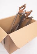 A collection of metal bygones: including three meat saws of various designs, two salt cutting saws,