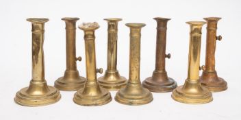 Eight various 19th Century brass ejector candlesticks:.