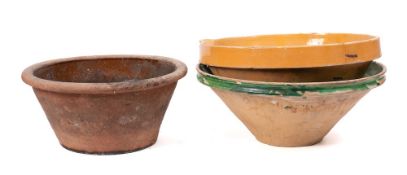 A French green slip glazed terracotta single lipped circular dairy bowl:, 44cm diameter,