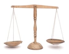 A set of fruitwood dairy scales: with turned ash central stem and twin circular pans.