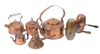 A circular drum-shaped copper kettle: with swing loop handle, two copper teapots,