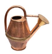 A copper and brass banded watering can: of twin conical form with brass rose, 38cm high.