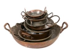 Ten copper and tinned twin-handled circular shallow pans: of varying sizes.