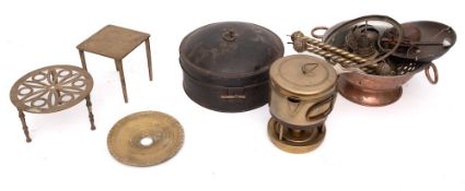 A circular tin spice box: with six divisions, 20cm diameter, two small brass trivets,