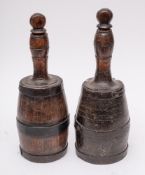 Two 19th Century iron bound wood decanters: of mallet shape, with stoppers, 35cm and 36cm high.