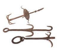 An iron two tier chimney hook:, each tier with four tines, also two iron butcher's hooks,