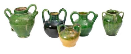 A green slip glazed olive oil jar:, 22cm high, another 16cm high,