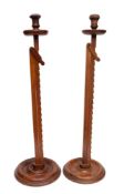 Two walnut adjustable candle stands:,