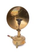 A brass reflector lamp: with concave shield and circular oil font.