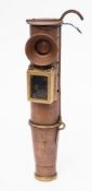 An unusual copper signalling lamp: of telescope design with brass framed hinged sighting cover,