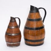 An iron coopered olive oil jug: of pear shape, 39cm high and a smaller olive oil jug, 29cm high.