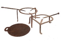 An iron brandreth: of bell shape on tripod feet, 51cm long, also a circular iron brandreth,