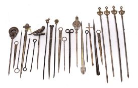 A set of four steel meat skewers: with pierced foliate scroll terminals,