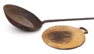 An iron long handled frying pan:, 144cm long, also a circular iron griddle pan with handle at side,