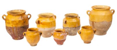 Two French pottery and yellow slip glazed twin-handled comfit jars:, 26cm high,