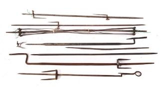 A wirework spiral spit: and seven various metal spits.