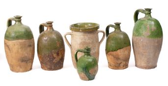 Four French terracotta and green slip glazed casks: of varying sizes,