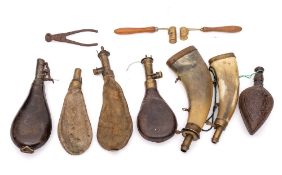 Two horn and brass mounted powder flasks:, five leather, suede and carved wood powder flasks,