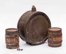 A French oak and iron coopered upright brandy barrel:, the side with initials L.J.