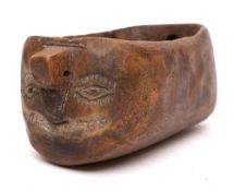 An unusual Pyrenean wooden water pourer: of oval-shaped outline, one end carved with a face, 32.