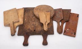 A collection of wood butter pats:, chopping boards, etc.