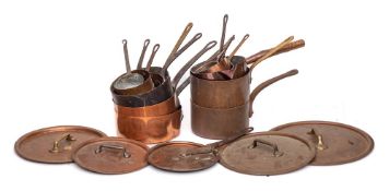 Fourteen various open copper and tinned saucepans: with iron, brass and wood handles,